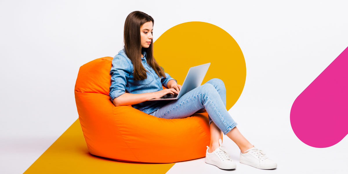 woman typing while sitting on a beanbag
